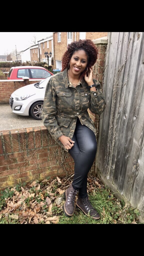 Burgundy red crochet braids, khaki belted jacket, leather-look skinny jeans, brown military-style Winter boots